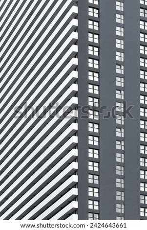 Minimalistic photo of a part of a modern grey and white apartment building.