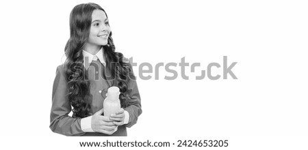 Happy child hold yellow plastic bottle with liquid food isolated on white, childhood nutrition. Horizontal poster of isolated child face, banner header, copy space. Royalty-Free Stock Photo #2424653205