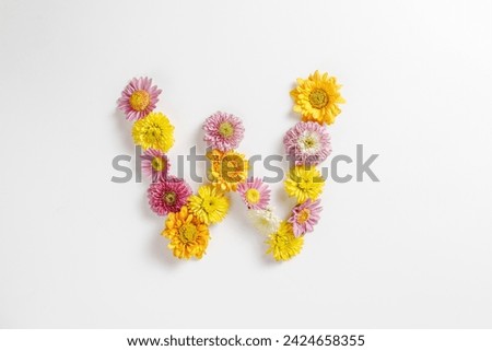 Letter W made of real natural flowers.