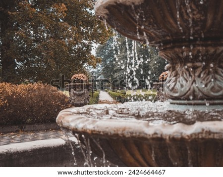 Water flowing in fountain located in park. Detailed picture