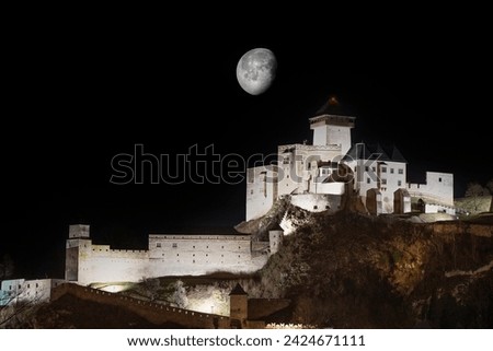 Moon in the night sky above the castle.