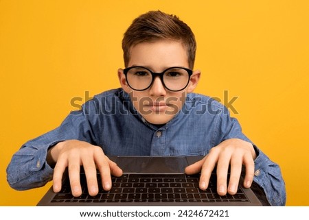 Pov Shot Of Nerdy Teen Boy In Glasses Using Laptop, Excited Male Child Looking At Computer Screen And Typing On Keyboard, Posing Against Yellow Studio Background, Webcam Point Of View