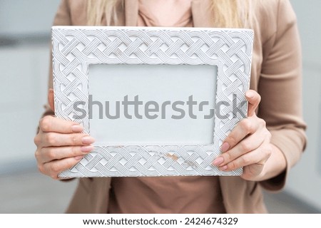 White photo frame in hand on white background. Isolation