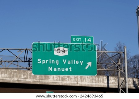 sign on I-287 I-87 NY State Thruway in Nanuet, New York for Exit 14 for NY-59 to Spring Valley and Nanuet Royalty-Free Stock Photo #2424693465