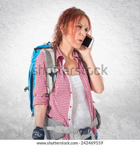 backpacker talking to mobile over textured background
