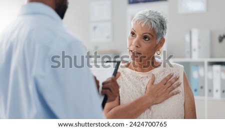 Patient, doctor and chest pain for consultation advice with clipboard for checklist or inflammation, Indigestion or infection. Female person, wellness and retirement or lung illness, healing or help Royalty-Free Stock Photo #2424700765