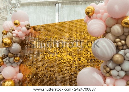 A large festive photo zone for a birthday, decorated with gold sequins, pink, gray and gold balloons of different sizes. Celebrating concept	
