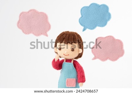 Small and cute Amigurumi doll on white background.Childcare