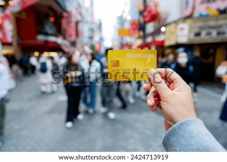 Travel card, Tourist woman showing credit card or travel card for convenient travel Make shopping easy enjoy lifestyle travel city at shopping street on holiday vacation in Japan