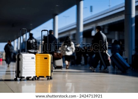 Travel, Two suitcases in an empty airport hall, traveler cases in the departure airport terminal waiting for the area, vacation concept, blank space for text message or design Royalty-Free Stock Photo #2424713921