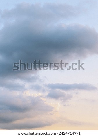 A serene and tranquil sky scene during sunset. Royalty-Free Stock Photo #2424714991