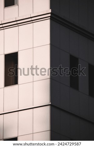 an interesting picture of the side of the building painted with windows and very beautiful sun shadows