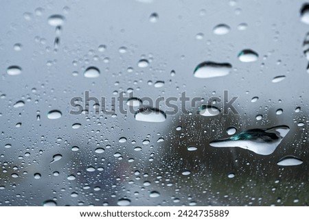 
We see an abstract photograph, a simple rainy day, a fogged glass, water drops of different sizes and textures, forming a special image, Mendoza Arg.