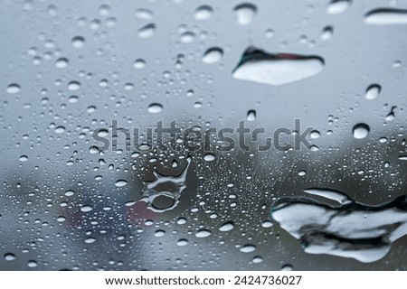 
We see an abstract photograph, a simple rainy day, a fogged glass, water drops of different sizes and textures, forming a special image, Mendoza Arg.