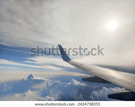 Airplane wings with  sun and blue sky background