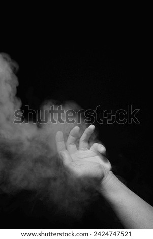 hands smoke in the dark at high resolution image and isolated with blurry ends