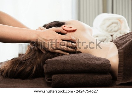 The woman is receiving a head massage. Royalty-Free Stock Photo #2424754627