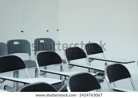 a picture of a class with rows of chairs in it