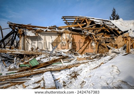 A ruined wooden house on a winter day