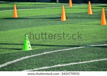 artificial green grass soccer field with training cones