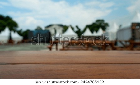Wooden table with blurred background of event tent