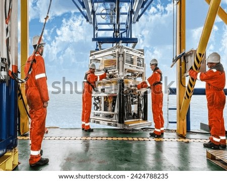 Personal basket tranfer form supply boat to oil gas rig offshore during crew change by boat. Royalty-Free Stock Photo #2424788235