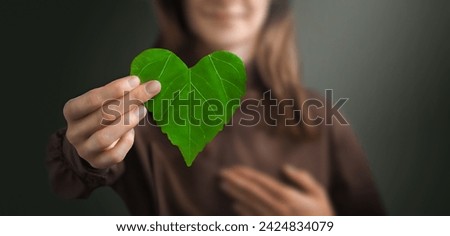 Business woman holding a green heart leaf Corporate Company Business with corporate social responsibility and environmental concern. Environmental and Ecology Care Concept.. ESG Concept. Nature 