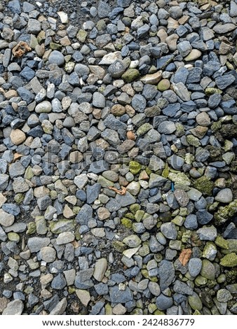 road gravel stone background, seamless dark gravel stone texture Royalty-Free Stock Photo #2424836779