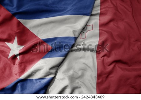 big waving national colorful flag of malta and national flag of cuba . macro