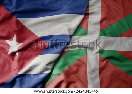 big waving national colorful flag of basque country and national flag of cuba . macro