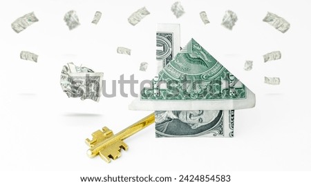 Home and money. House made from one dollar bill on grey background. Model house with keys. Key for the house. Real estate concept