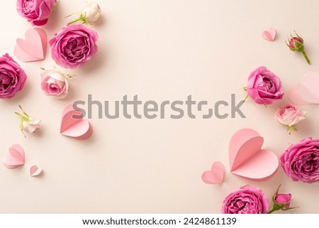 International Women's Day setup. Top view of delicate paper hearts, and fresh rose buds on a gentle beige canvas, providing space for text or promotional content