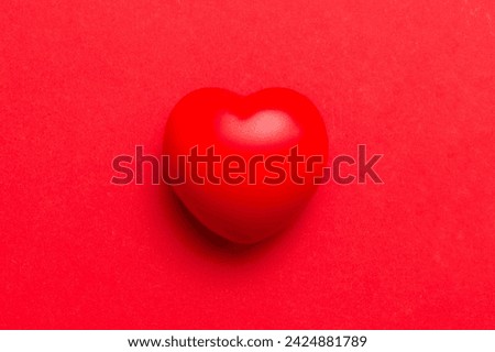 red heart shape on colored background. minimal concept top view with copy space.