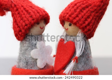 Two small dolls with heart.Valentines day background