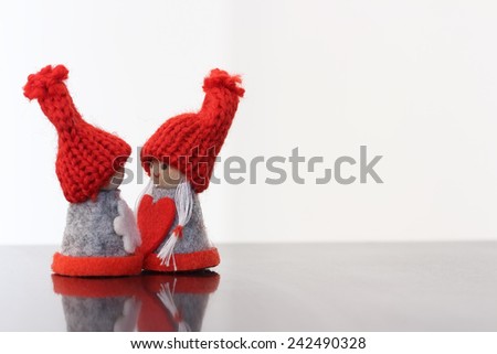 Two small dolls with heart.Valentines day background
