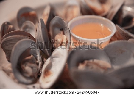 Steamed clams with butter served at a pub Royalty-Free Stock Photo #2424906047