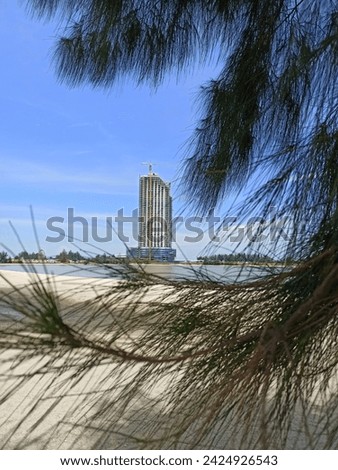 A picture of a building on a beach. clear sky when the picture was taken