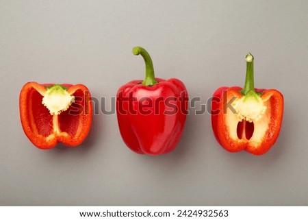 Red sweet pepper on grey background. Space for text. Top view Royalty-Free Stock Photo #2424932563