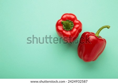Red pepper on mint background. Space for text. Top view Royalty-Free Stock Photo #2424932587