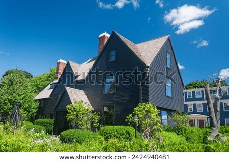 A flower garden at the house of the seven gables in Salem Massachusetts on a sunny day. Royalty-Free Stock Photo #2424940481