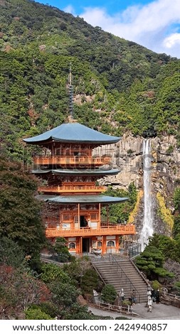Three-story pagoda of Seiganto-ji, Three-story pagoda of Seiganto-ji with Nachi Falls in the background can make a good picture.  Royalty-Free Stock Photo #2424940857