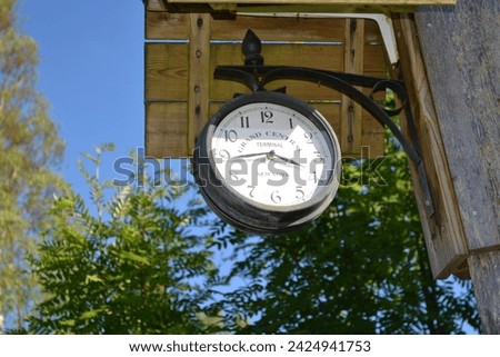"Relativity of time and space": a copy of classic, vintage clock from Grand Central terminal in New York in an environment of unspoiled nature in Dalsland, Sweden. June 12, 2015. Royalty-Free Stock Photo #2424941753