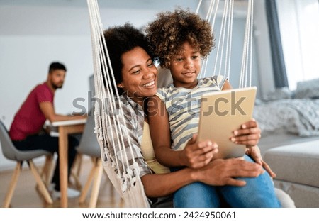 Portrait of happy mother with child using digital tablet for education, fun, game. Technology people