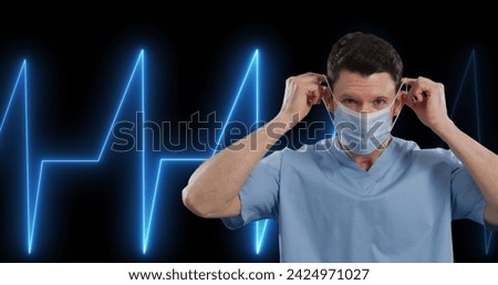 Image of life line over caucasian doctor on black background. Global medicine, technology, data processing and digital interface concept digitally generated image.