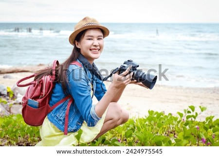 Asian woman traveling at sea taking photos at the beach. Travel concept, traveler. Sea tourism, Thailand.
