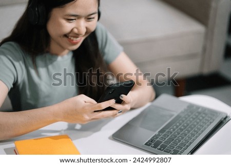 Women are using a mobile phone wifi connection on the desk with a cup of coffee in the morning.
