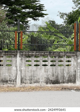 old concrete wall with white concrete and gray fence
