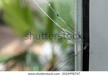Broken Glass Window Burglary: Emergency Glass Replacement and Property Damage Royalty-Free Stock Photo #2424998747