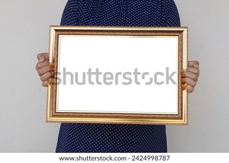 Closeup woman holds empty photo frame or blank diploma certificate frame. Copy space for adding text or photos. Concept, Proud, memories and nostalgia .                            