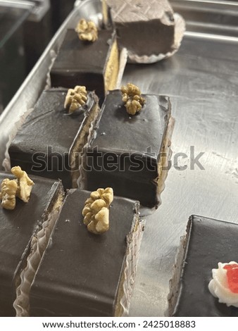 The image features a chocolate cake adorned with gold decorations.